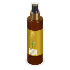 Forest Essentials body mist bottle with gold sprayer, amber glass and yellow label