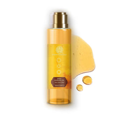 Body massage oil bottle with gold cap; amber oil with a few visible drops