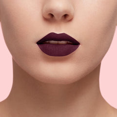 Matte lip color on lips, deep plum-dark berry shade