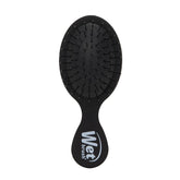 Black mini detangling hair brush with flexible bristle cushion and grip handle