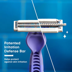Shaving razor cartridge with purple irritation defense bar, close-up