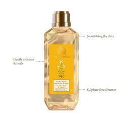 Forest Essentials silkening shower wash bottle with gold cap and yellow label, side benefit callouts