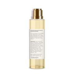 Back of after bath oil bottle with cream body, gold pump cap, ingredient label panel