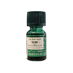 The Body Shop tea tree oil 10ml bottle, dark green glass with black cap