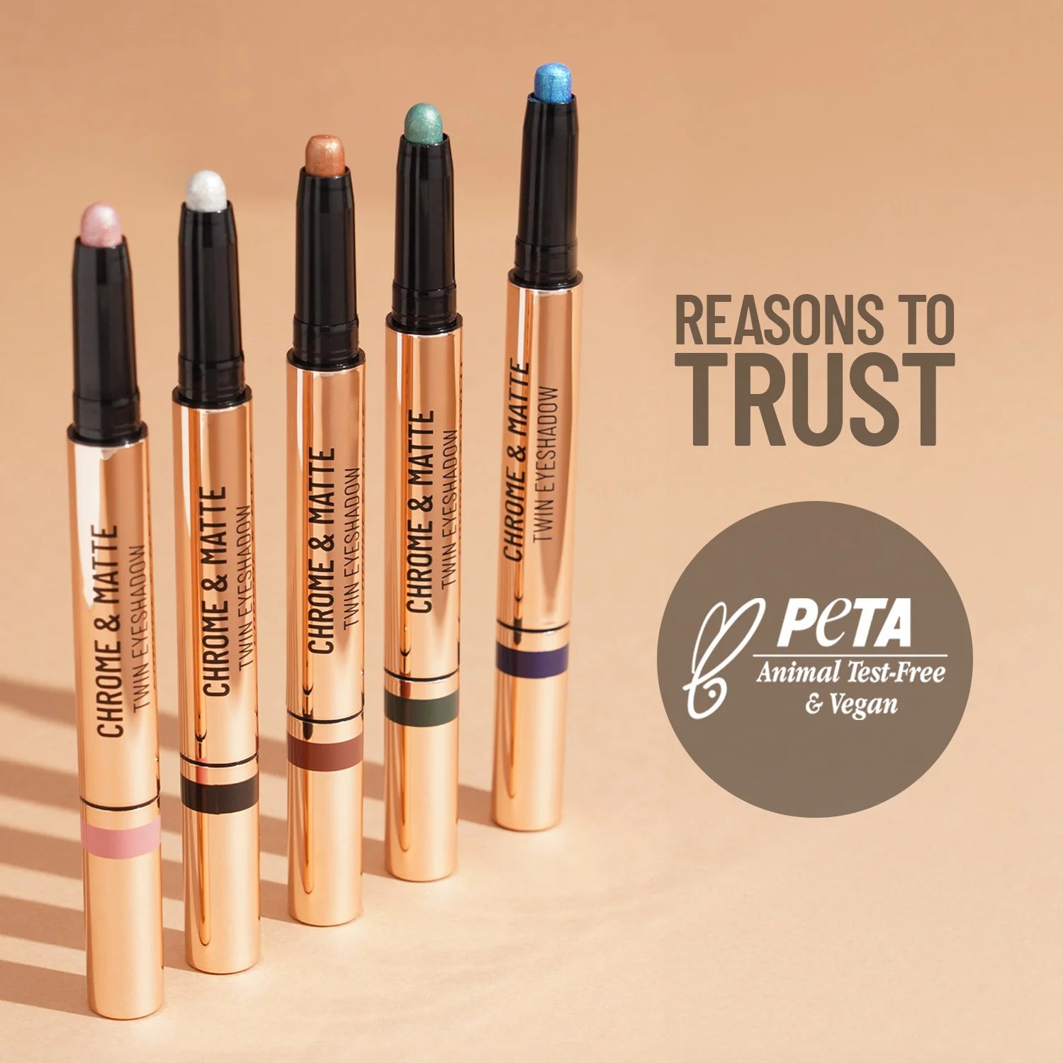 Twin eyeshadow sticks with chrome and matte tips, including teal accent shade