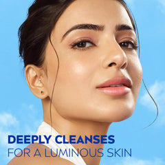 Woman’s face close-up with face wash effect on skin