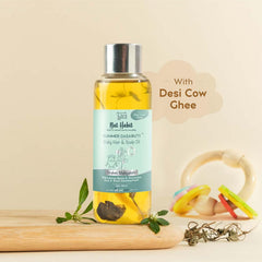 Baby hair and scalp oil bottle with “Desi Cow Ghee” label, yellow oil in clear vial.