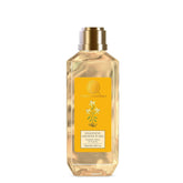 Forest Essentials silkening shower wash bottle, clear amber with gold cap and yellow label