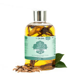 Baby massage oil bottle with silver cap, amber oil, teal label