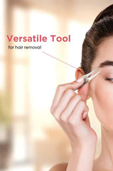 Stainless steel hair removal tweezer with beige rubber grip held near the eye
