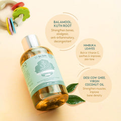Baby massage oil bottle with silver cap, amber oil, teal label and green leaves