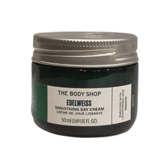The Body Shop Edelweiss smoothing day cream jar, dark green glass with white label