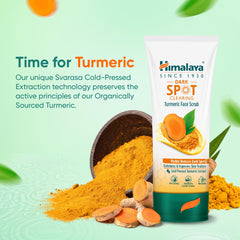 Himalaya turmeric face scrub tube beside powdered turmeric and turmeric chunks