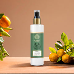 Forest Essentials facial moisturizer bottle with gold pump and black cap, with orange and leaves