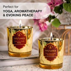 Two SoulFlower Rang glass votive candles in amber glitter glass, flames visible