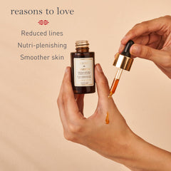 Kama Ayurveda face oil bottle with dropper, shown being applied by hand
