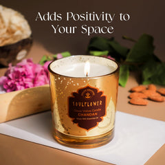 Amber glass votive candle with flame, speckled gold glitter finish, CHANDAN label
