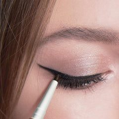 Eye makeup close-up with black kohl eyeliner along the lash line and waterline
