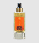 Room spray bottle with gold pump and orange label, clear glass with 100 ml size