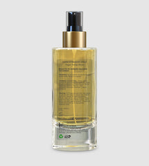 Room spray bottle back view with gold pump, clear glass and printed ingredient panel