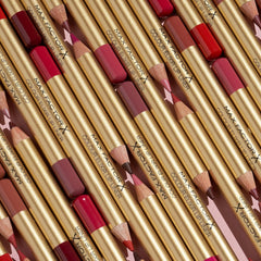 Cluster of gold lip liner pencils with nude, rose, and red-tinted tips