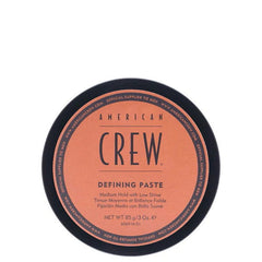 American Crew Defining Paste jar lid, black rim and peach label, medium hold hair paste.