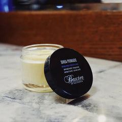 Shea pomade jar with black cap and yellow-cream pomade in container