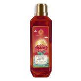 Body oil bottle with gold pump and amber glass, decorative label front