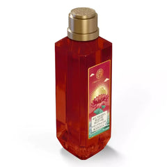 Body oil bottle with gold cap, amber liquid, side label panel