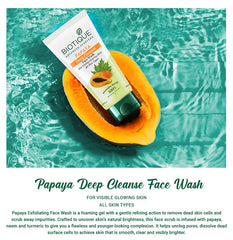 Papaya deep cleanse face wash tube with green base, on halved papaya fruit
