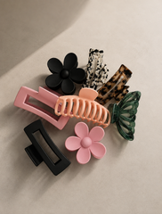 Flower hair claw clip set with pink, black, and green claw grips for easy updos