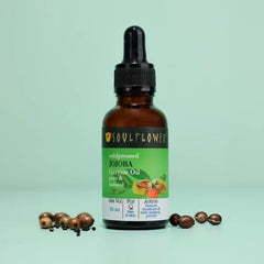 Jojoba oil bottle with black dropper, amber glass, with jojoba beads nearby