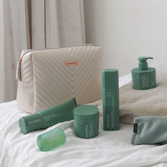 Davroe CURLiCUE hair care set with quilted pouch and green bottles, pump bottle