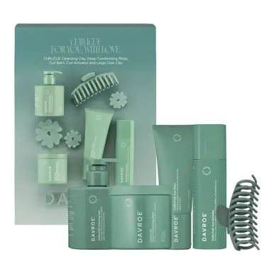 Teal CURLiCUE hair care set with bottles, tubes, and matching hair brush