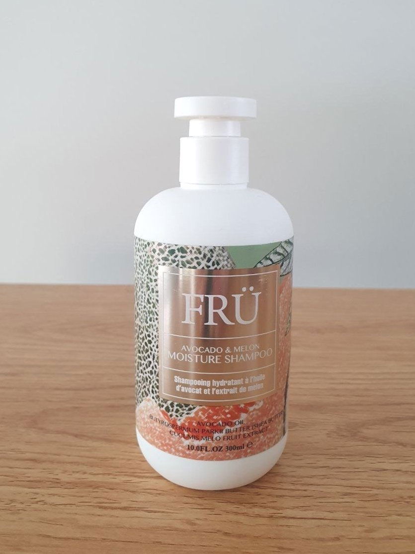 FRU shampoo bottle with white cap, coconut & vanilla repair label.
