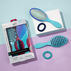 Detangling brush and comb kit with teal brush, pink bristles, and coiled hair ties