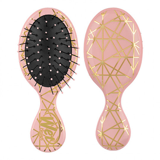 Mini detangler hair brush, peach pink with gold geometric pattern and black bristles.