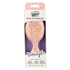 Wet Brush Mini Detangler package, peach pink brush with gold geometric design on card.