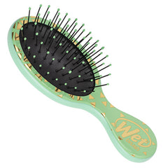 Mini detangling brush, jade-green handle with geometric confetti, black pin pad