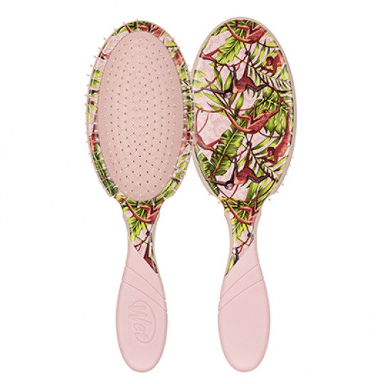 Pink oval hair detangling brush with plant-and-animal safari print pad