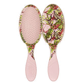 Pink oval hair detangling brush with plant-and-animal safari print pad