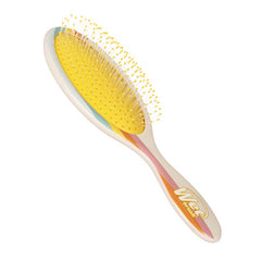 Detangling hair brush with yellow bristle head and rainbow striped handle, Wet