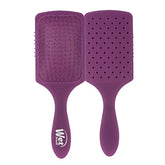 Purple paddle detangler hair brush with cushioned pad and grip handle.