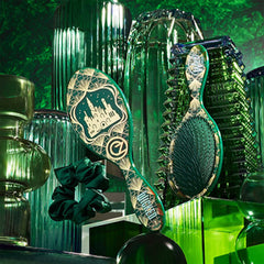 Detangling brush pair with dark green scrunchie, shown upright