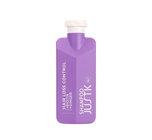 Purple biotin and ginger shampoo bottle with flip-top cap, front label visible.
