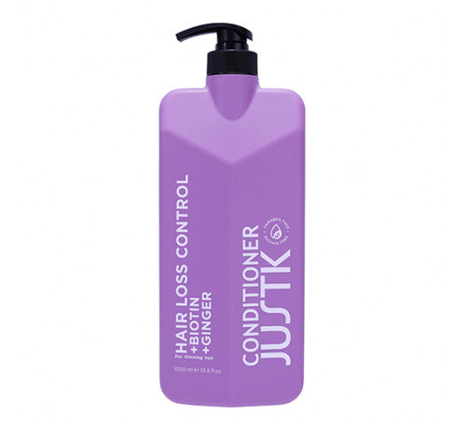 Purple hair conditioner bottle with black pump dispenser