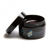 Hair pomade jar with open black lid and scooping tool, blue label