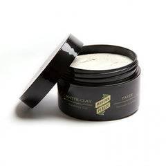 Matte clay paste jar with open lid and creamy white paste surface