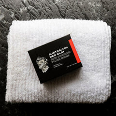 Red clay Australian soap box on light towel