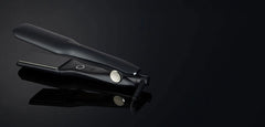 Wide hair straightener, black body with indicator light and glossy plates